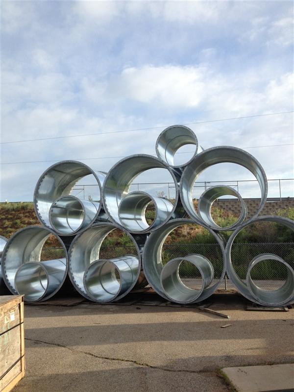 Flanged round duct sections staged in the yard