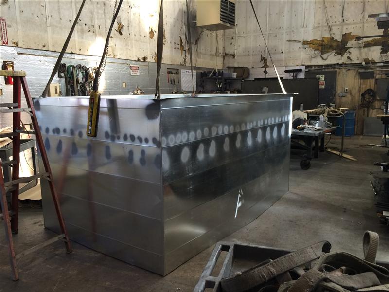 Large rectangular duct section hanging from a hoist