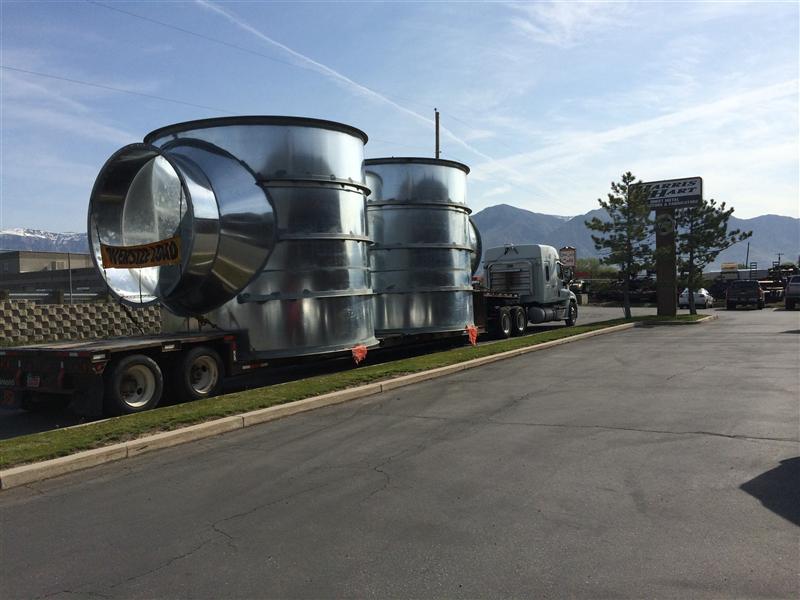 Oversize load of large round fittings leaving the shop