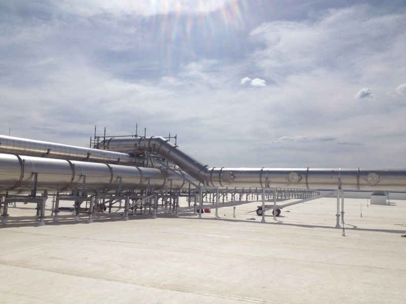 Long runs of round exhaust duct on supports across a flat rooftop